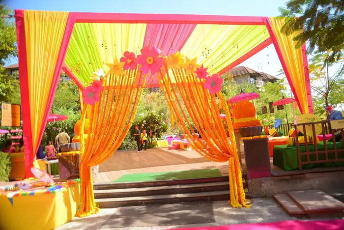 Yellow and orange drapes at an outdoor haldi